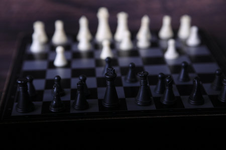 Black and white chess pieces on a chessboard. selective focus.