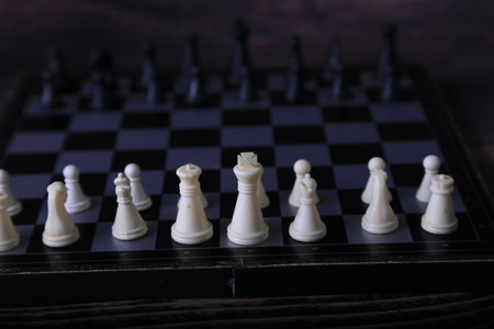 Chess board and chess pieces on wooden background. selective focus. Toned.の写真素材