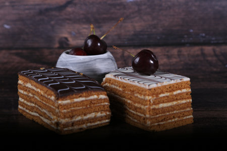 Cake with cherries on a dark wooden background. selective focus.