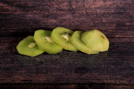 Sliced kiwi fruit on wooden background. toned.の写真素材