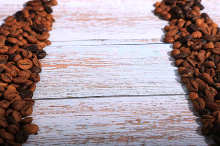 Coffee beans on wooden table, closeup. Space for textの写真素材