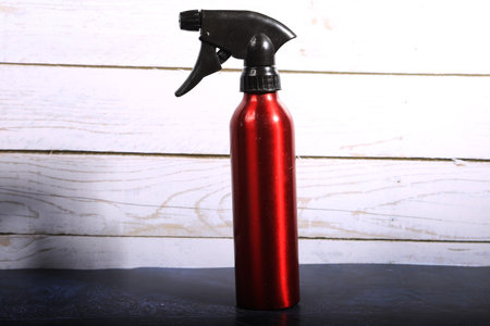 Spray bottle on a wooden background. Cleaning service concept.の写真素材