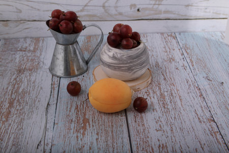 Grapes and apricots on a white wooden background.の写真素材