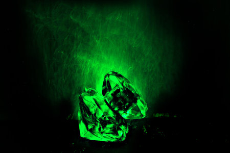 Green glowing crystal ball on black background. Close up. Selective focusの写真素材