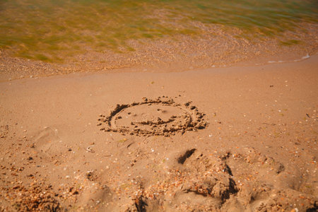The inscription on the sand in the form of a heart on the beachの写真素材