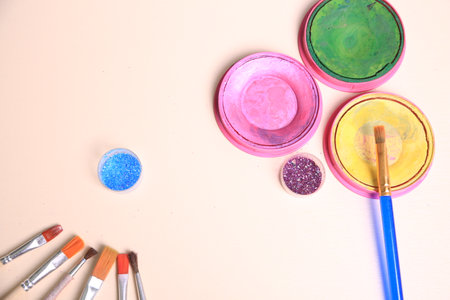 Brushes and paints on a white background, closeup of photoの写真素材