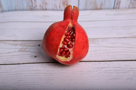 Ripe pomegranate fruit on wooden background. Close up.の写真素材