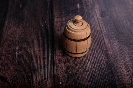 Wooden barrel on a dark wooden background. Selective focus. Toned.の写真素材