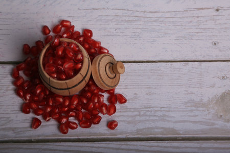 Pomegranate seeds on wooden background. Selective focus.の写真素材