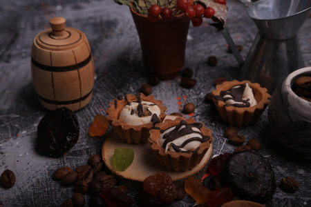 Coffee cupcakes with cream and chocolate glaze on a dark backgroundの写真素材