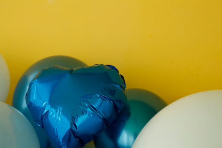 Colorful balloons on a yellow background with copy space for text.の写真素材