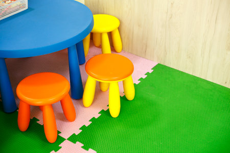 Colorful children's table and chairs on the floor in the roomの写真素材