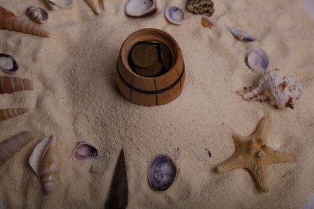Wooden barrel on the sand with seashells and starfishの写真素材