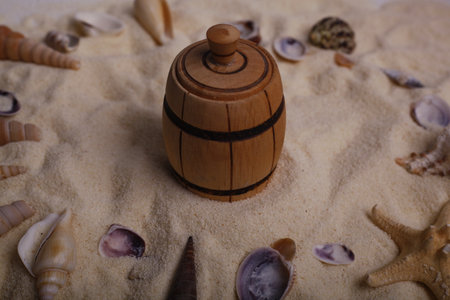 Wooden barrel on the sand with seashells and starfishの写真素材