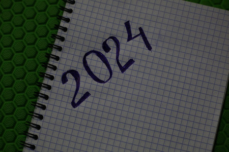 2021 is written in a notebook on a green background. Happy New Year.の写真素材