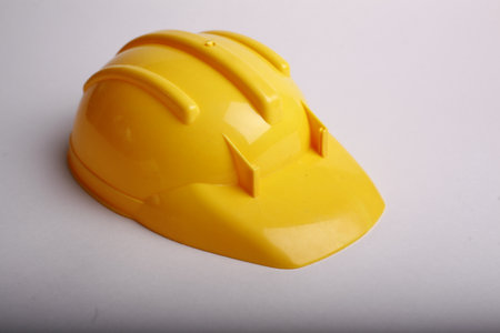 Yellow hard hat on a white background. Close-up. Studio shot.の写真素材