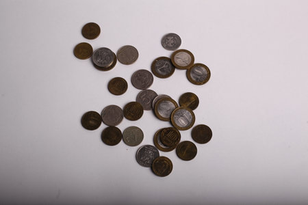Coins on a white background. Coins are scattered on the table.