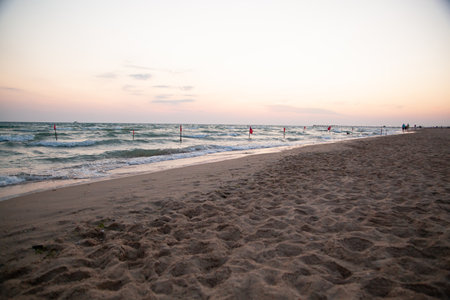 Beautiful sunset on the beach. Sea and sand in the evening.の写真素材
