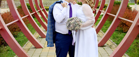 Bride and groom on their wedding day. Bride holds a bouquet of flowersの写真素材