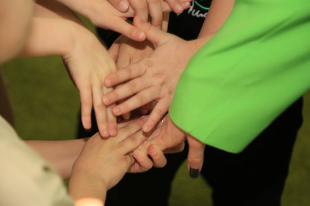 Group of children holding hands together, close-up. Teamwork concept