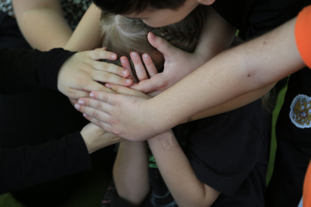 Closeup of the hands of a boy and a girl holding handsの写真素材