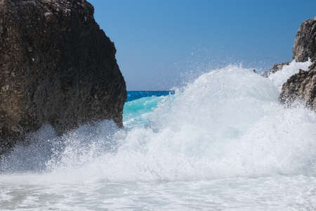 Stormy giant waves crash on the rocksの写真素材