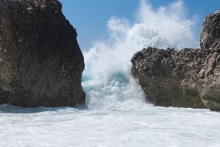 Stormy giant waves crash on the rocksの写真素材