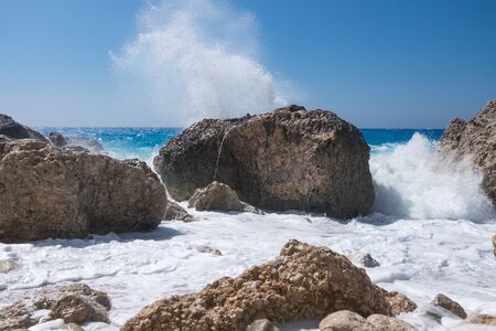 Stormy giant waves crash on the rocksの写真素材