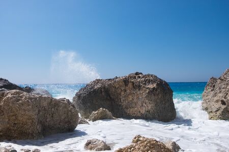 Stormy giant waves crash on the rocksの写真素材