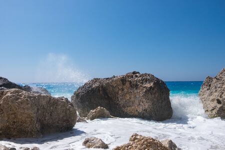 Stormy giant waves crash on the rocksの写真素材