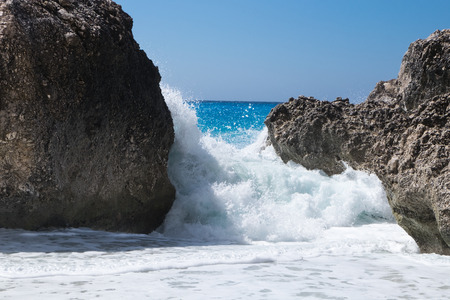 Stormy giant waves crash on the rocksの写真素材