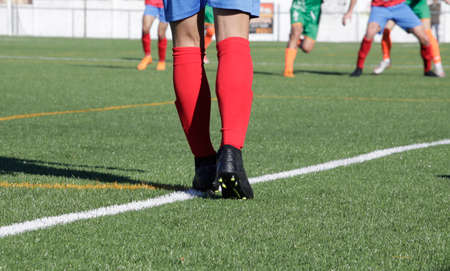 Players in a football match in an artificial grass fieldの写真素材