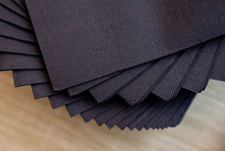 Set of black napkins placed with a wooden background