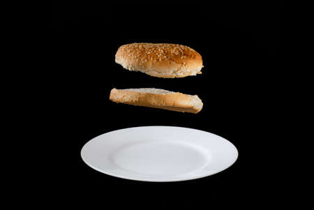 hamburger bread on a plate with black backgroundの写真素材