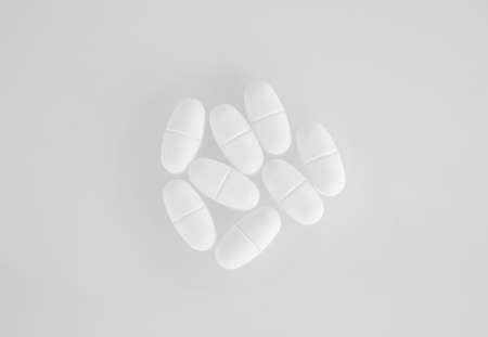 white pills on white background
