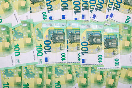 a bunch of 100-euro bills in the foreground