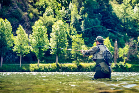 man fishing trout and salmon in the rivers of the Catalan Pyrenees with all the sport fishing...