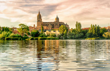 view of the cathedral of Salamanca in Spain reflected in the river tormes.の写真素材