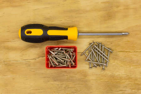 top view of screw driver and screw on wood backgroundの写真素材
