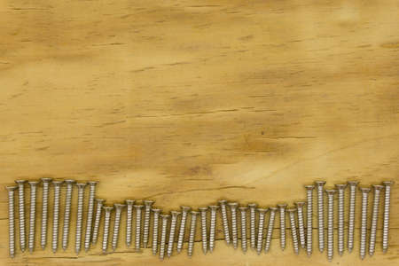 top view of screw on wood backgroundの写真素材