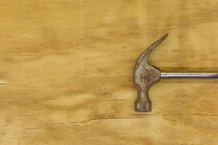 top view of hammer place in horizontal on wood backgroundの写真素材