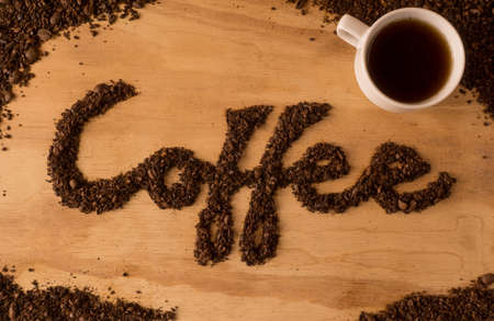 coffee text make from coffee bean on wooden backgroundの写真素材