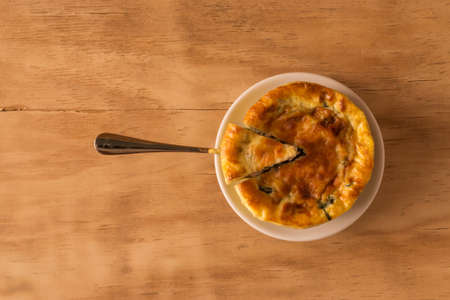 baked spinach with cheese on wooden backgroundの写真素材