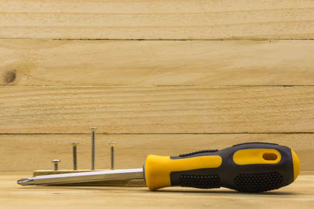 set head screw driver and screw on wood backgroundの写真素材