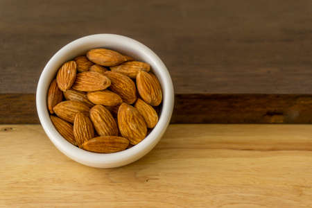 almond nuts in wooden backgroundの写真素材