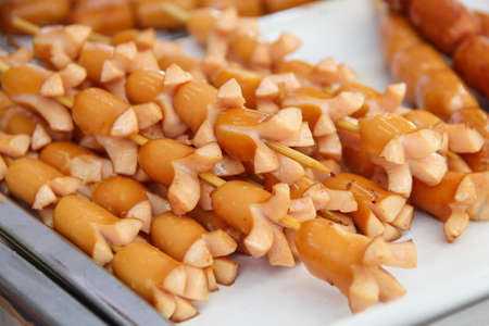 Fried sausage a grill on a stickの写真素材