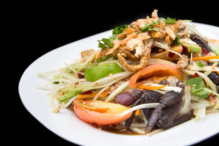 Papaya salad spicy with crabs and dry small shrimps on black backgroundの写真素材