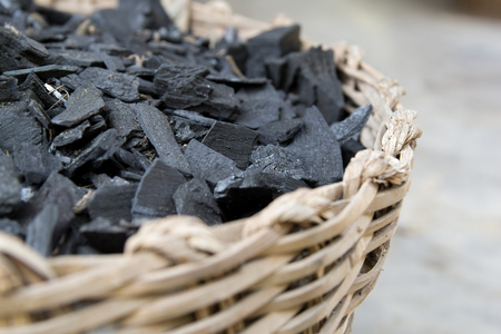 fraction of dust charcoal in the woven basket (selective focus)の写真素材