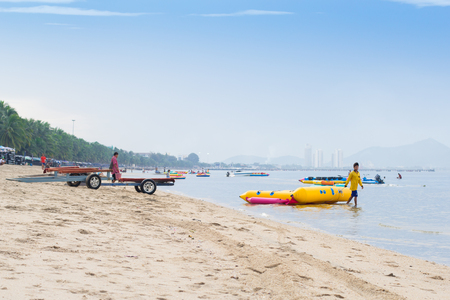 Chonburi, THAILAND - November 11, 2015: Man use rope for drag a banana boat to the seaの写真素材