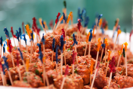 Isolated red meat with many colorful sticks on green blurred backgroundの写真素材